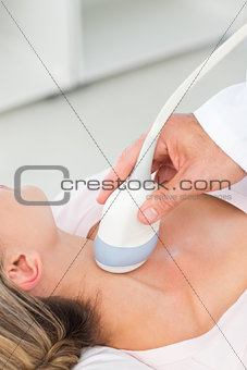 Woman getting an ultrasound scan on neck