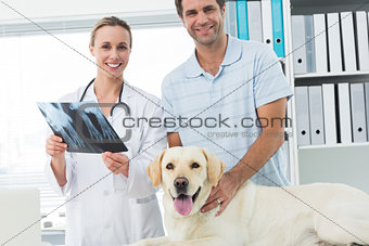 Pet owner and veterinarian with Xray of dog