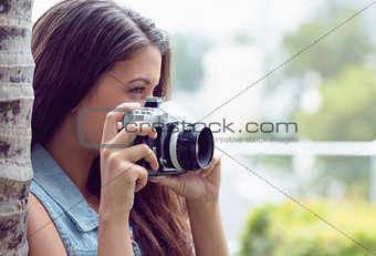 Pretty girl taking photographs outside