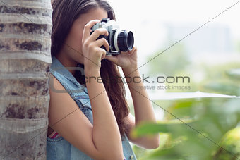 Young girl taking photographs outside