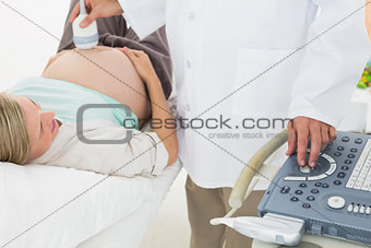 Blonde pregnant woman having a sonagram scan