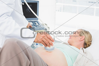 Happy pregnant woman having a sonagram scan