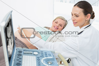 Happy pregnant blonde having an ultrasound scan