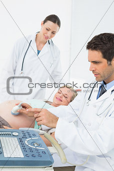 Excited pregnant woman having an ultrasound scan