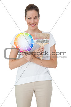 Portrait of a woman with paint samples and paintbrush