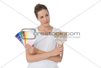 Young woman with paint samples and paintbrush