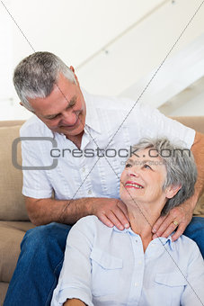 Man giving his senior wife a shoulder rub