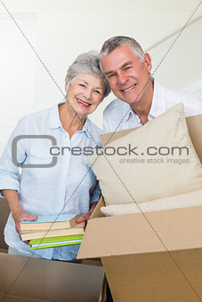Happy senior couple moving into new home