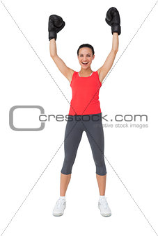 Portrait of a cheerful female boxer raising hands