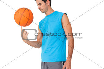 Basketball player holding ball on finger