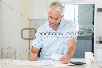 Concentrating man working out his finances