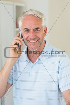 Smiling man on a phone call looking at camera