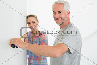 Happy couple making some measurements together