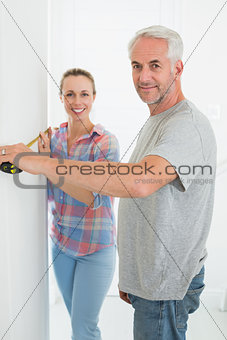 Happy couple making some measurements together