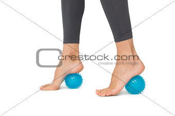Close-up low section of woman standing over stress ball