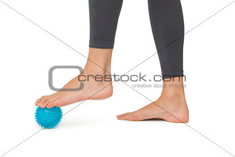 Close-up low section of woman standing over stress ball