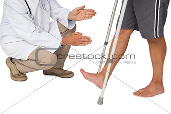 Low section of a doctor with senior man using walker