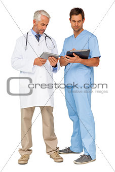 Male doctor and surgeon with digital tablets