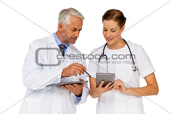 Male and female doctors with digital tablets