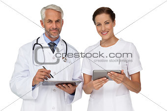 Male and female doctors with digital tablets