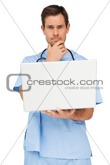 Portrait of a male surgeon using laptop