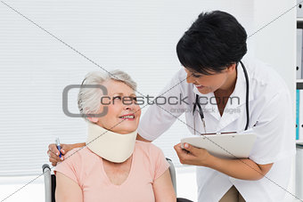 Doctor talking to a senior patient with cervical collar