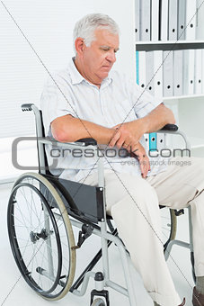 Sad senior man sitting in wheelchair