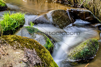 Falls on the small mountain river in a wood