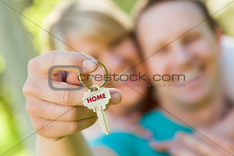 Couple Holding House Key with Home Text