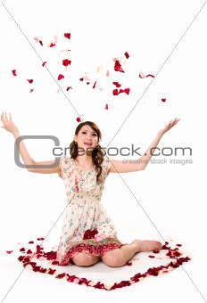 young girl tossing rose petal