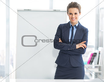 Portrait of happy business woman near flipchart