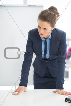 Concerned business woman near flipchart