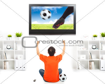 happy fan watching soccer game and raised hands