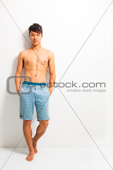 sexy young man standing and depend on wall