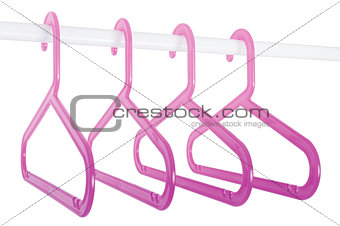 Pink hangers on a rod isolated on white
