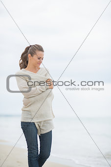 Young woman walking on cold beach