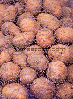 A net-bag with potatoes inside