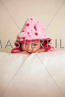 Two week old infant in pink polka dot hooded jacket
