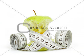 Green bitten apple isolated on white with measuring tape