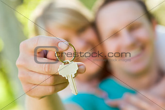 Happy Couple Holding Blank House Key Outside