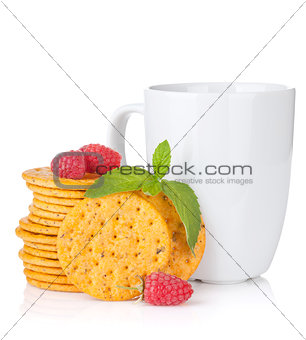 Stack of crackers with mint, berries and cup of drink