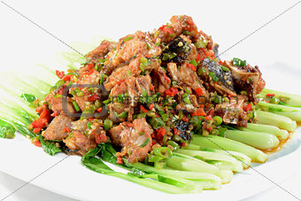 Chinese Food: Fried fish head pieces with green vegetables
