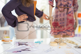 Closeup on accessories and fashion designer decorating mannequin