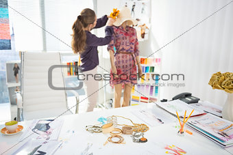 Closeup on accessories on table and fashion designer decorating 
