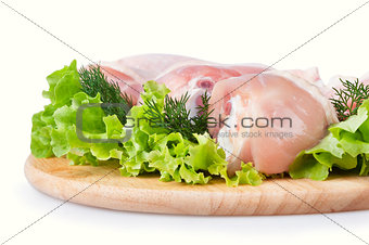 Raw chicken legs with green salad