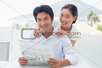 Couple reading a newspaper together