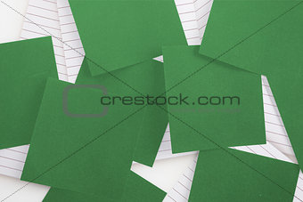 Green paper strewn over notepad