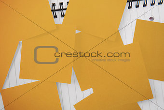 Yellow paper strewn over notepad