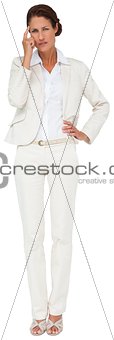 Thinking businesswoman with hand on hip