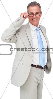 Thinking mature businessman touching glasses